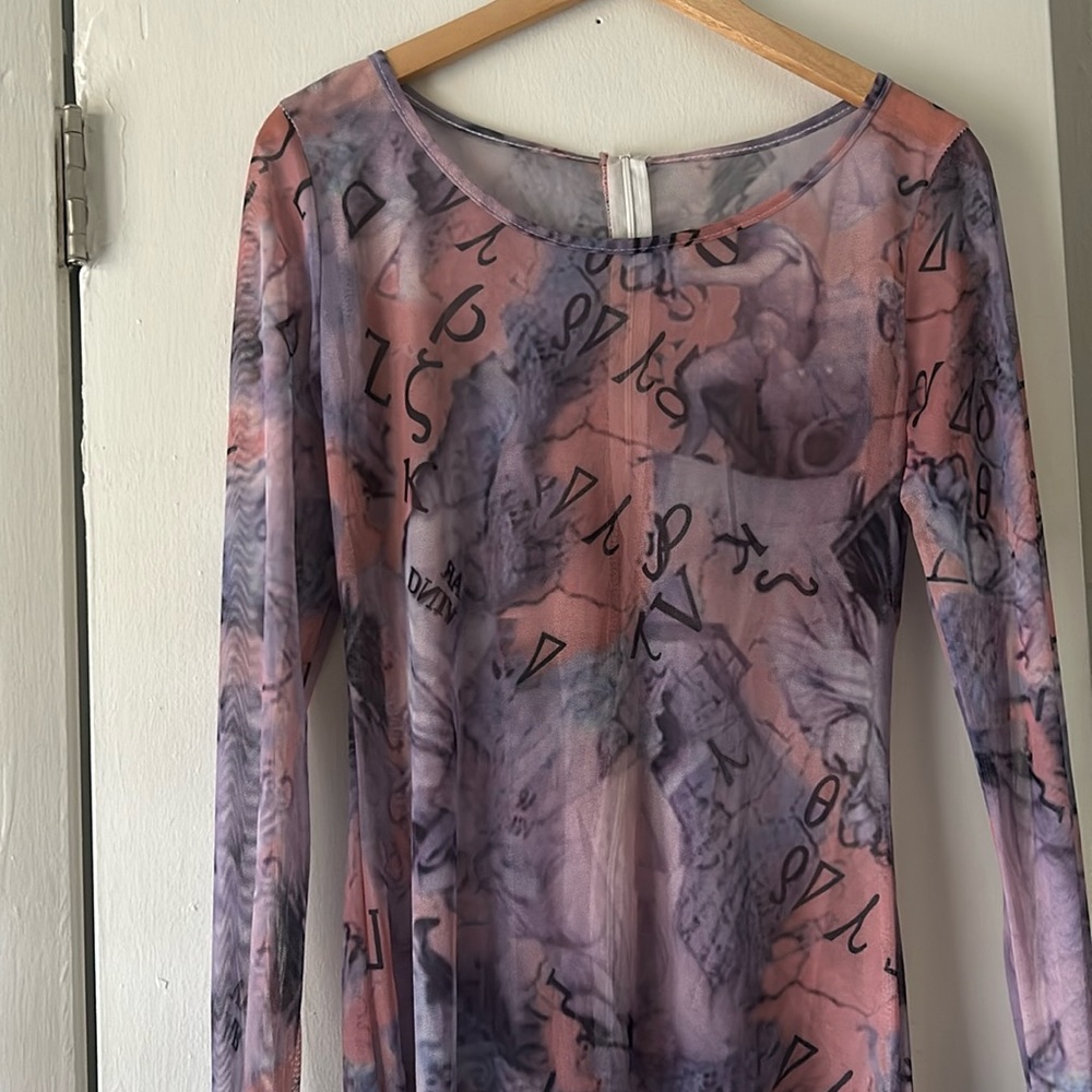 This lovely short jumper . Zips up in the back.